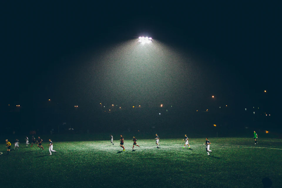 Group of people playing soccer on soccer field
