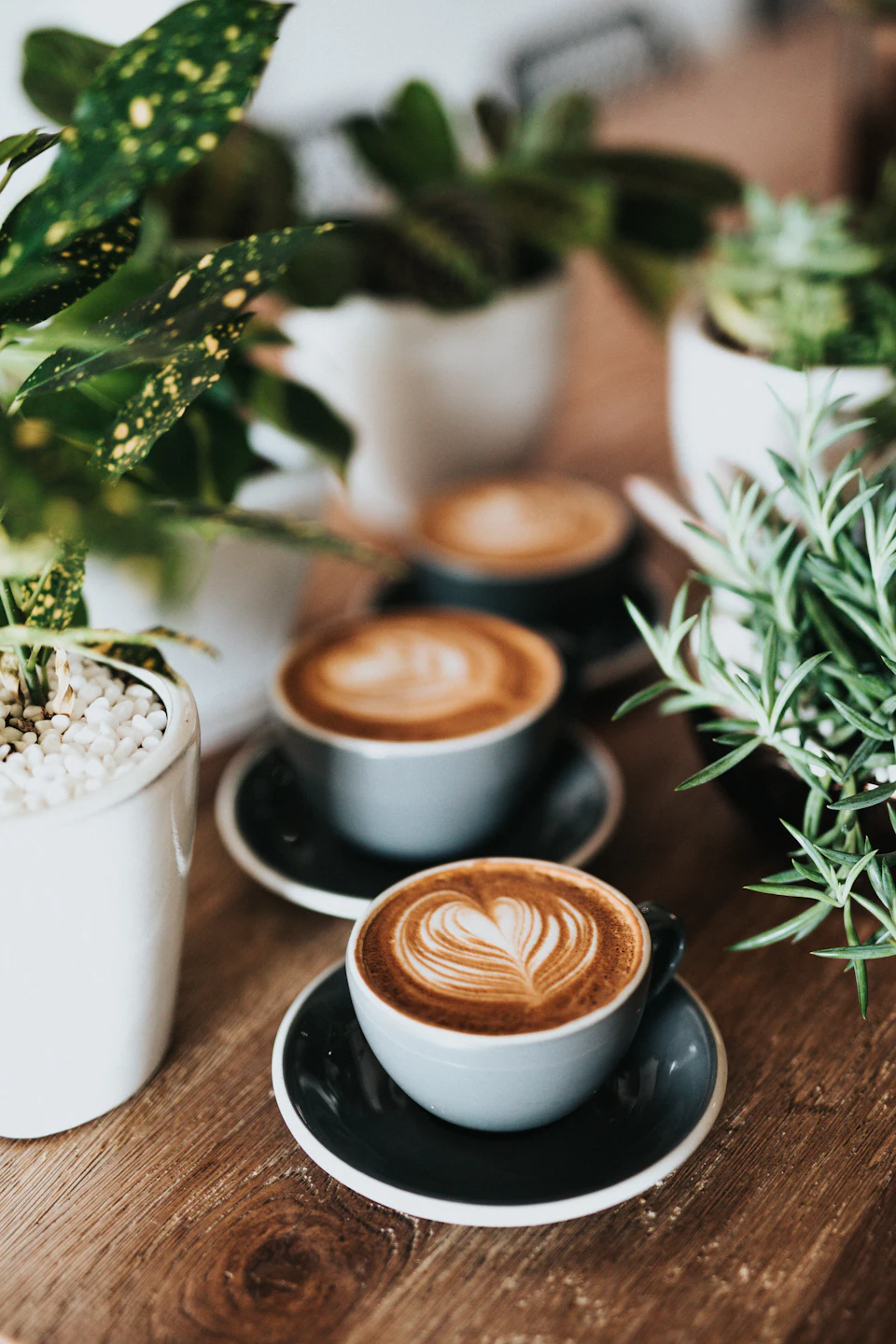 Shallow focus photography of coffee late in mug on table
