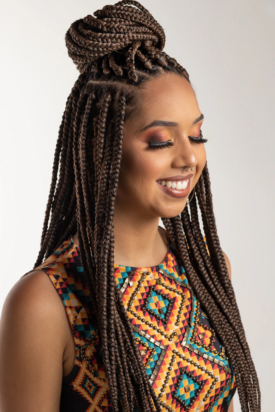 Woman wearing multicolored blouse and braided hair