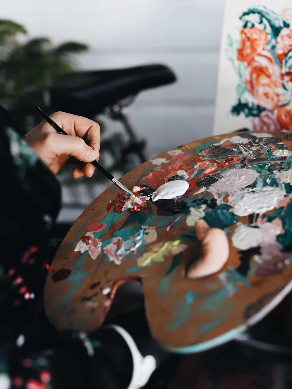 Person holding paint brush while painting