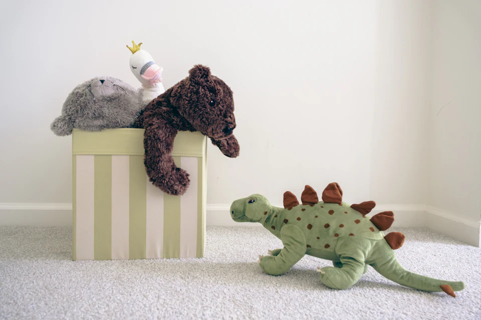 Two stuffed animals sitting on top of a box